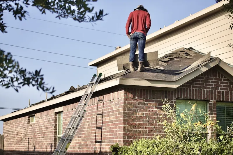 Professional roofer working on a residential roof in Chester Plaza